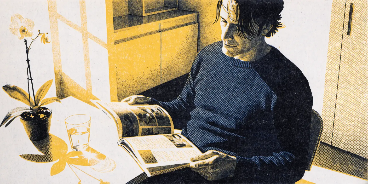A relaxed man in his forties, shown from the chest up in a crisp navy sweater, sits in a sunlit aesthetic clinic waiting room, calmly reading a magazine beside a small orchid and a glass of water.