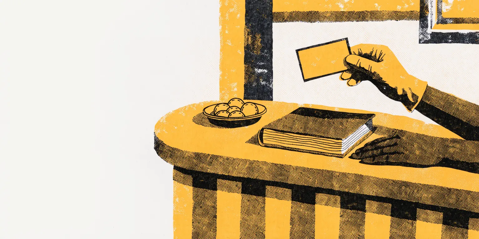 A gloved hand holds a blank loyalty card above a reception desk at an aesthetics clinic, while beside it a second hand rests on a closed appointment book next to a small dish of unmarked tokens.