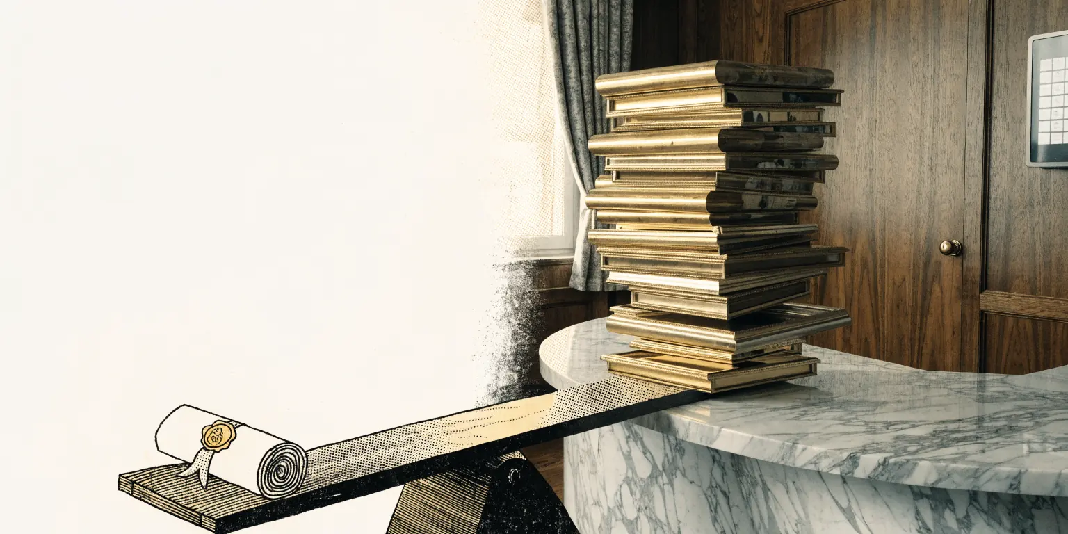 On a marble reception counter in a walnut-paneled private clinic, a tall stack of glossy gold-framed portrait frames leans over a seesaw, outweighing a single small brass-sealed certificate scroll on the other end, soft daylight.
